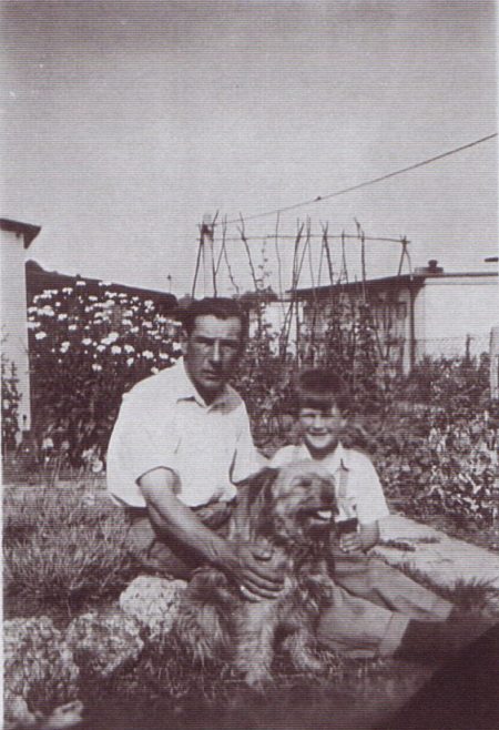 George in garden with dog. Excalibur Estate, London SE6