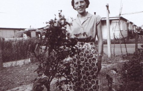 Jim's mum by the rose bush in the prefab garden. Excalibur Estate, London SE6