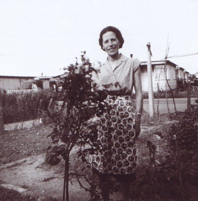 Jim's mum by the rose bush in the prefab garden. Excalibur Estate, London SE6