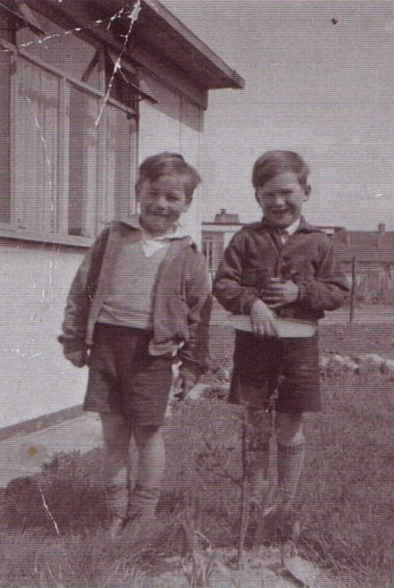 Jim and friend outside the prefab. Excalibur Estate, London SE6