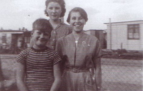 Jim and two girls outside the prefab. Excalibur Estate, London SE6