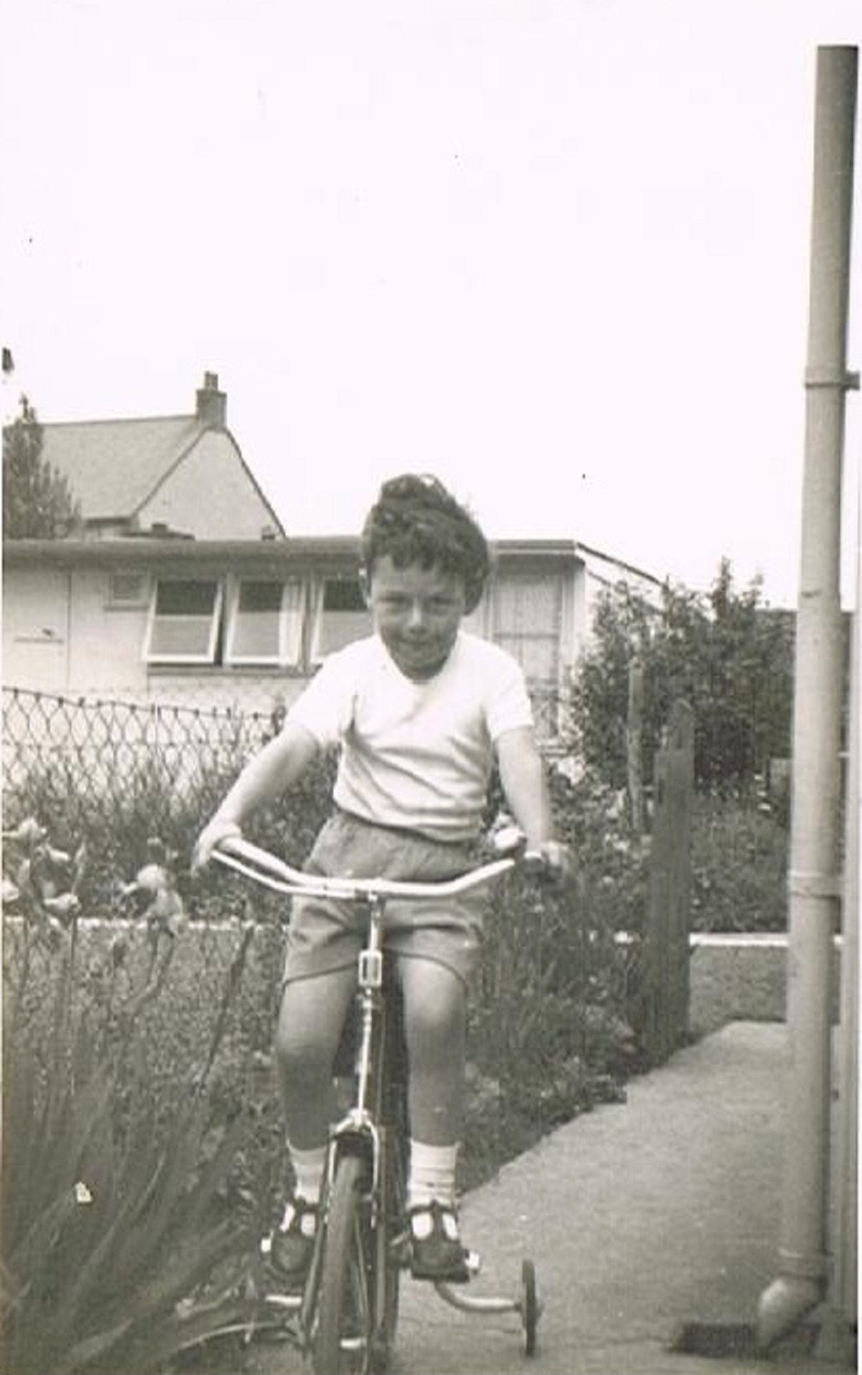 Bernard on his bike in the prefab garden. 60 Harewood Road, Coventry