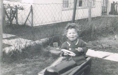 Bernard in his toy car, prefab garden. 60 Harewood Road, Coventry