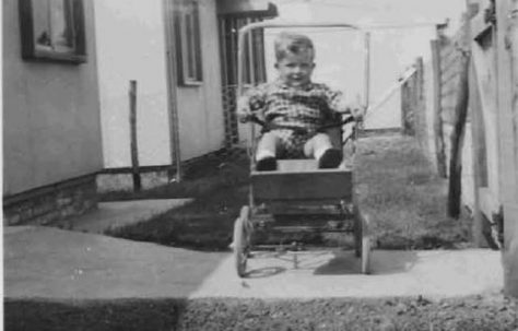 Bob in his pushchair outside the prefabs. Barnfield Road, St Mary Cray