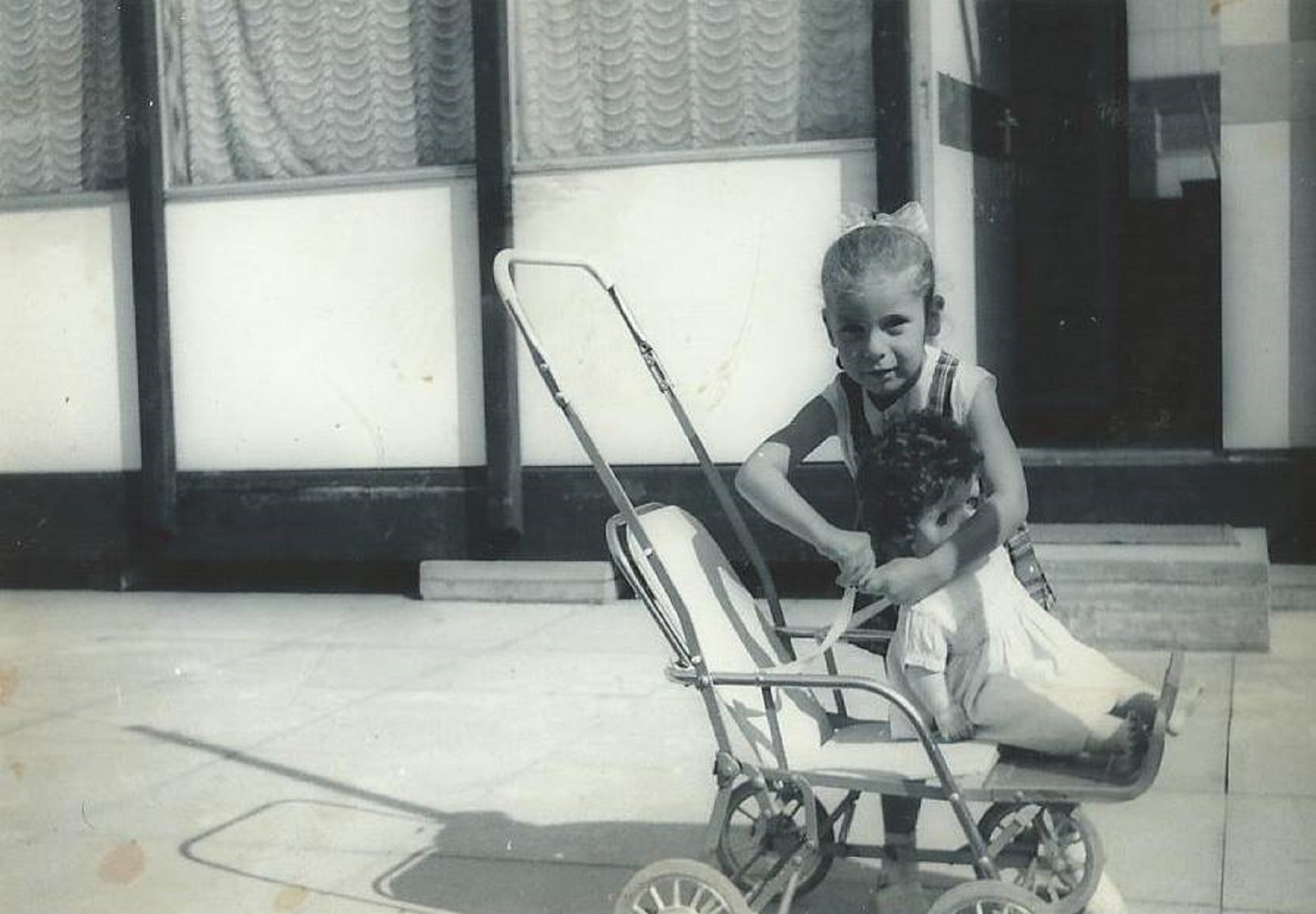 Dave's sister with her doll's pram. Essian Street, Stepney