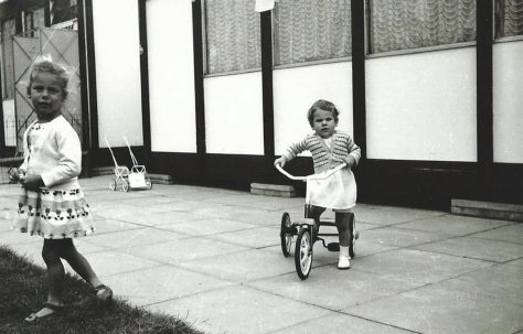 Two girls one riding a tricycle. Essian Street, Stepney