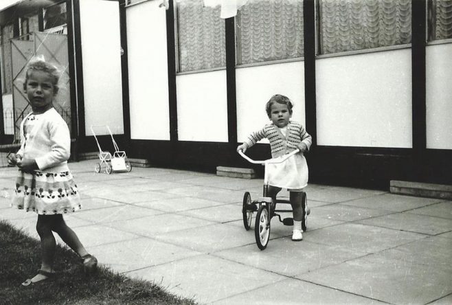 Two girls one riding a tricycle. Essian Street, Stepney