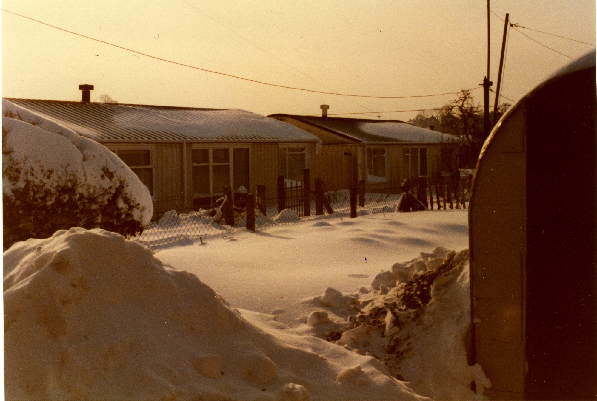 Arcon prefabs in the snow, Treberth estate, Newport