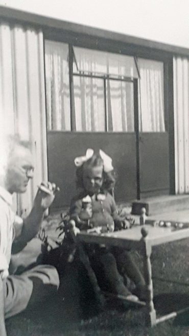 Lesley eating ice cream with her dad in the garden at Avelon Rd. Romford.