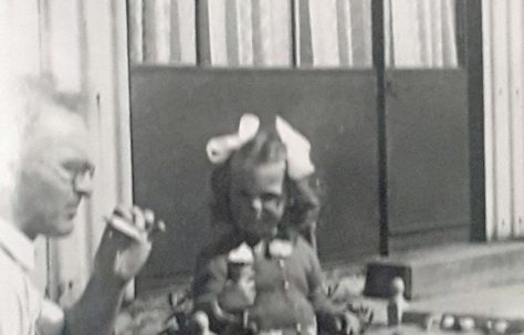 Lesley eating ice cream with her dad in the garden at Avelon Rd. Romford.