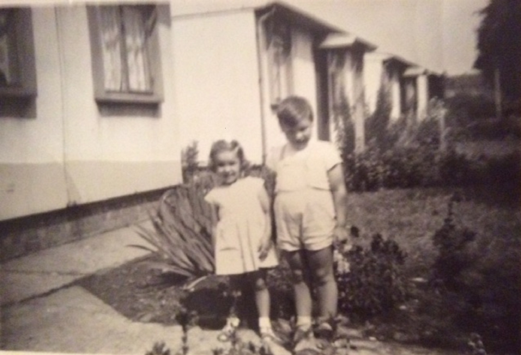 Billy and Angela outside their prefab at 8 Cedar Way, Acton W3