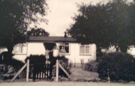 Bill and Maria cleaning the windows at their prefab at 8 Cedar Way, Acton W3