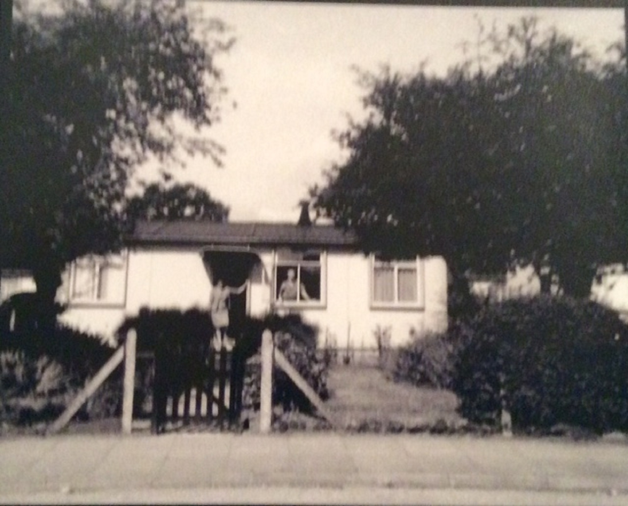 Bill and Maria cleaning the windows at their prefab at 8 Cedar Way, Acton W3