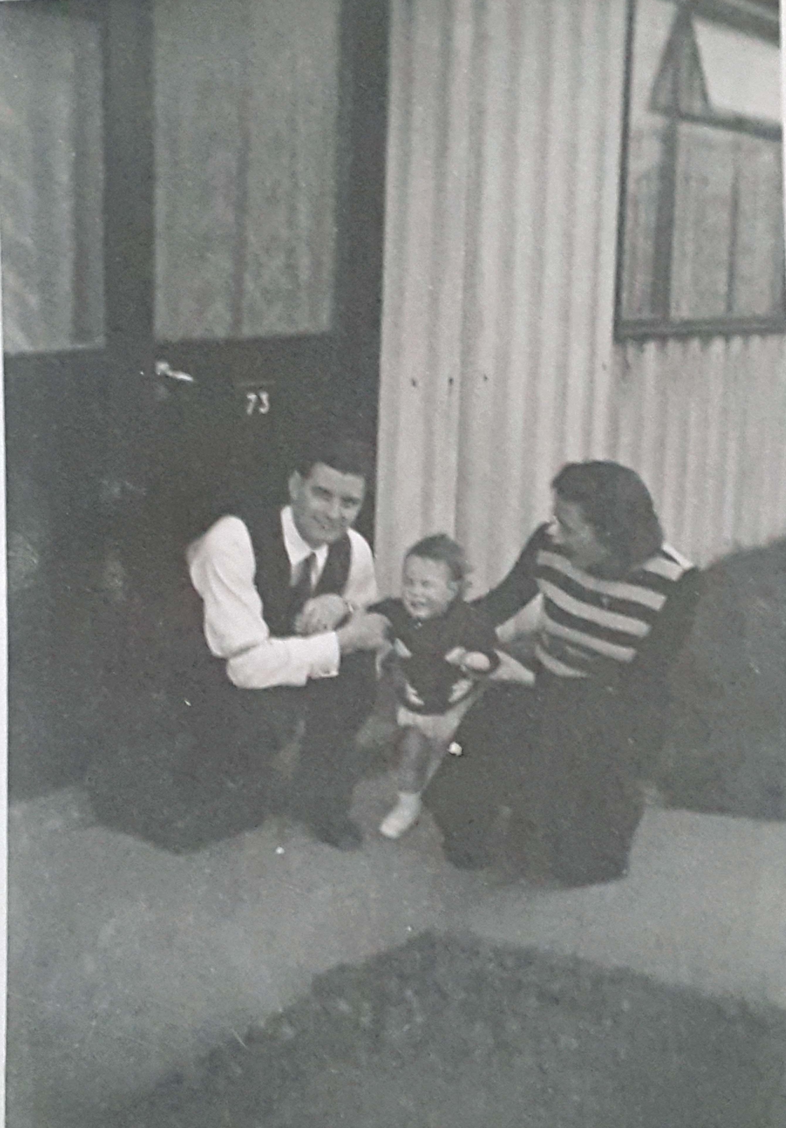 Auntie & Uncle with my brother outside the prefab at Avelon Road. Romford.