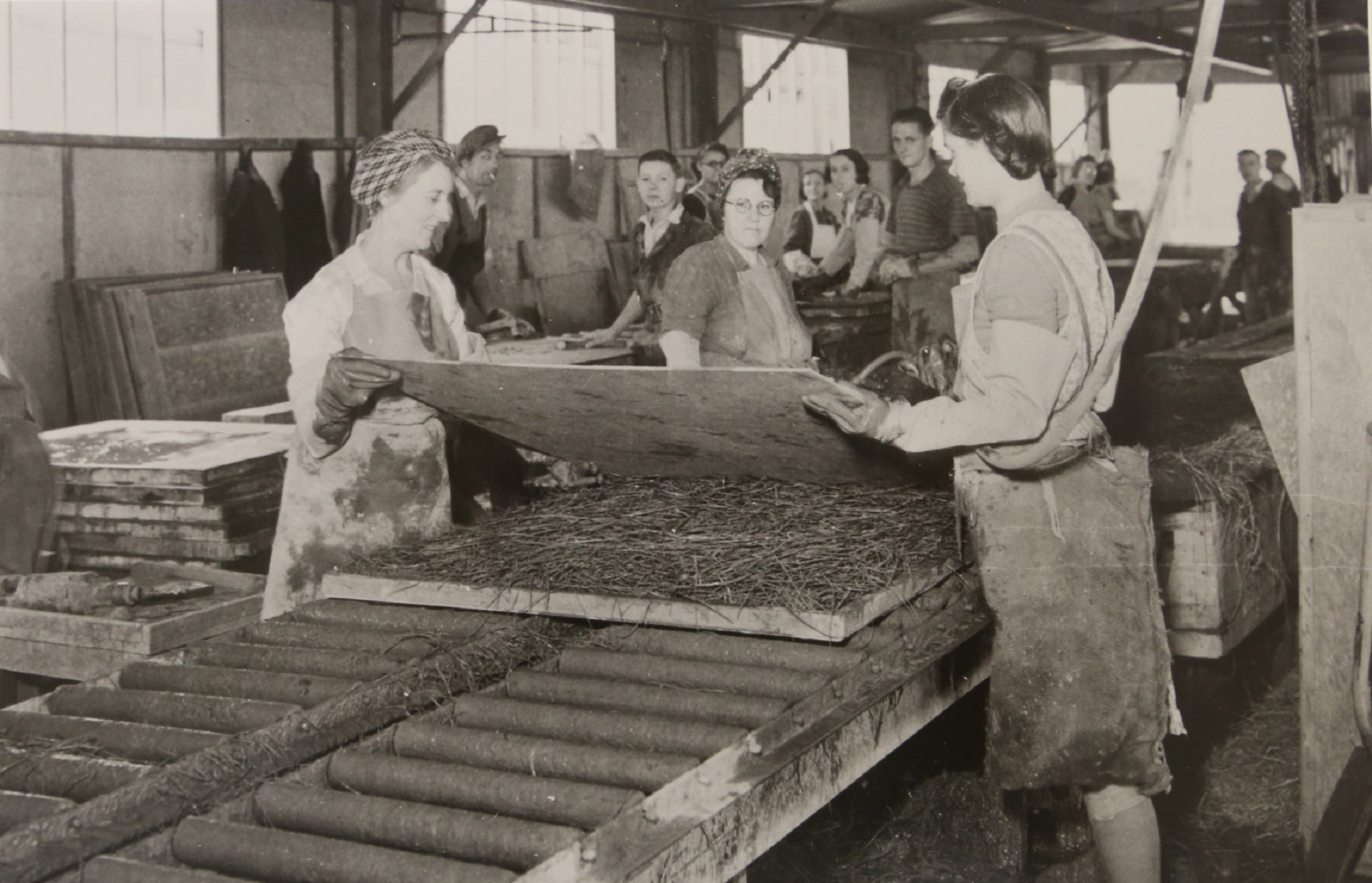 Factory workers assembling insulation for the prefabs