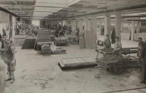 Factory workers assembling insulation for the prefabs