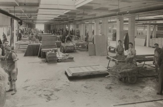 Factory workers assembling insulation for the prefabs