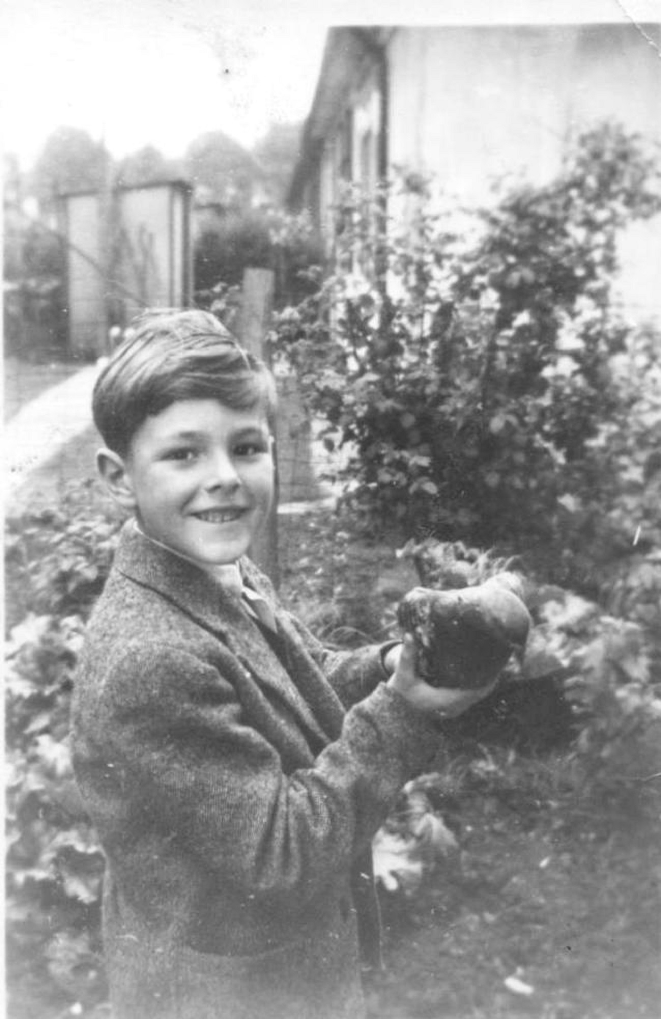 Robert holding a racing pigeon he found and restored to its owner, taken on Coronation day. Kendal Road, London NW10