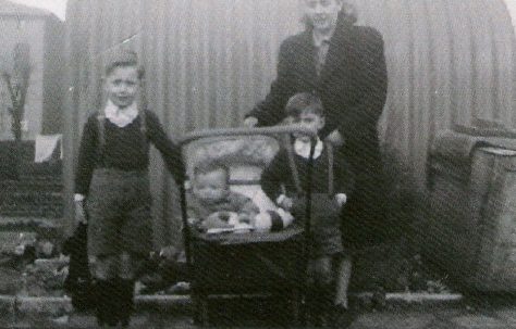 Mum and we three boys, posing outside the Anderson shelter. This would have been in 1948, judging by my physical size in the pram.