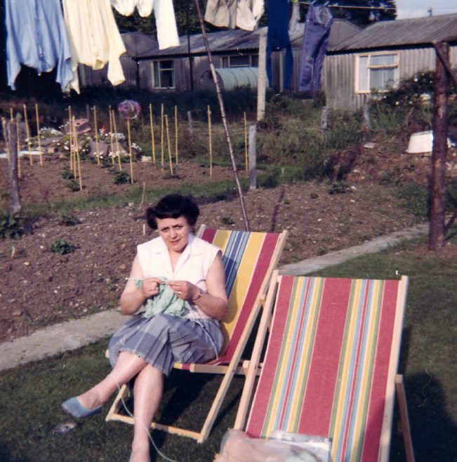 Elsie knitting in the prefab garden. Sixth Street, Pollards Hill