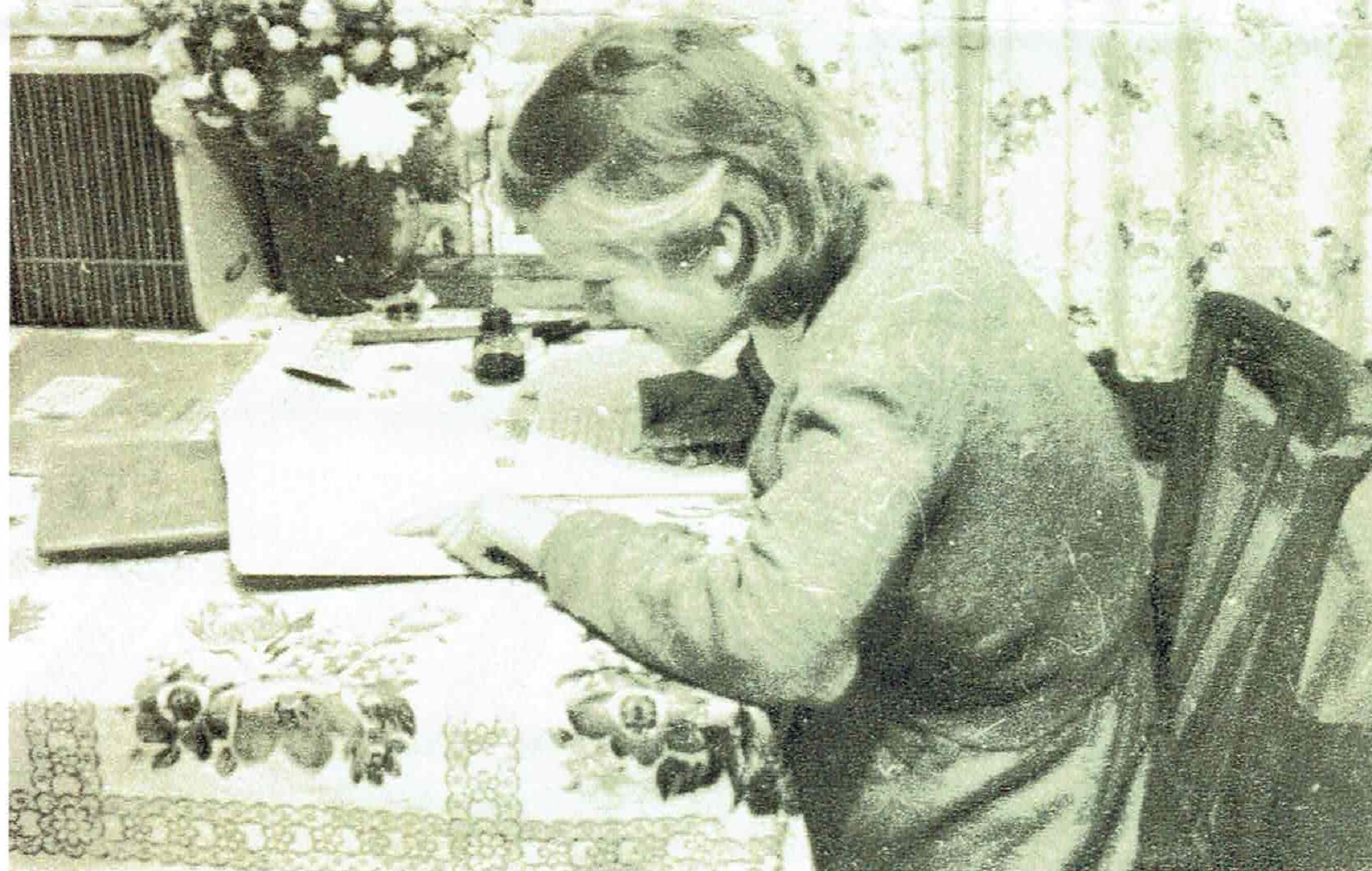 Brenda Attwell (now Ward) doing my homework on the table by the window in the living room. Port Talbot Place, Fforestfach, Swansea