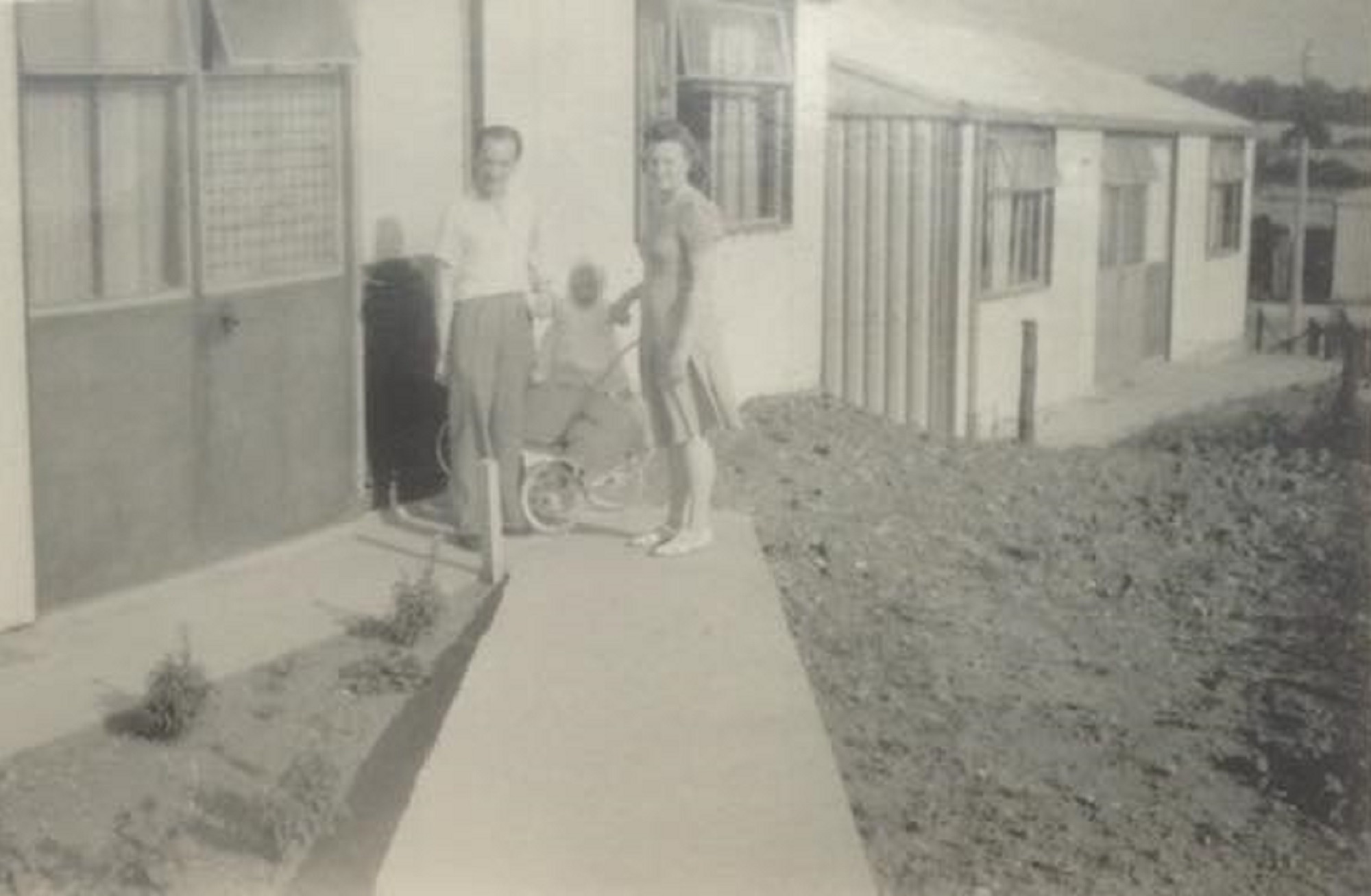 Denise and her mum and dad outside the prefab. Oakwood Hill, Loughton, Essex