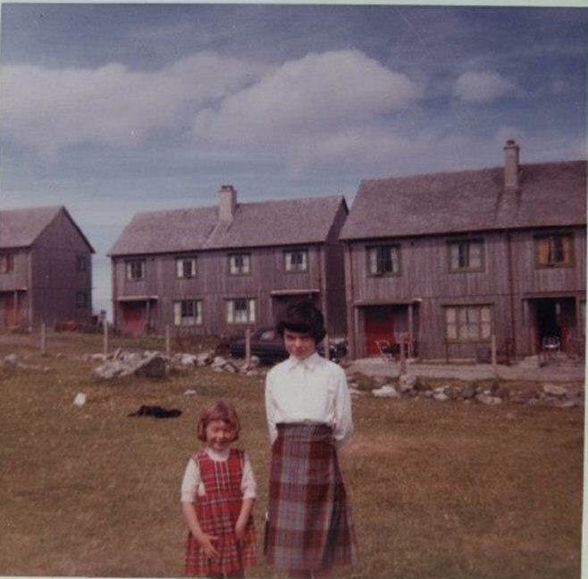 Joan and her sister. Swedish houses, Columba Place, Benbecula | Joan Brady