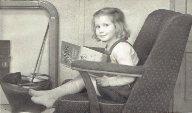 Julie sitting by the fire in the prefab. Cotton Avenue, Acton, London