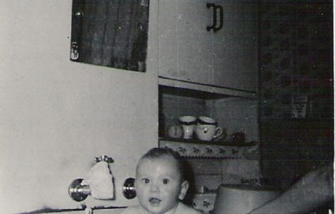 Graham having a baby bath in sink, 849 Ripple Road