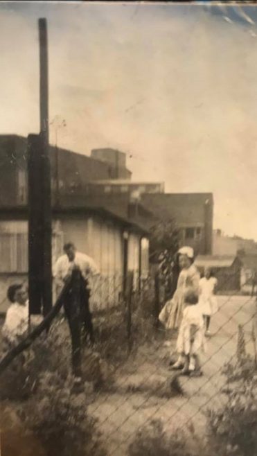 Sue (with bow in her hair) and her mum and dad in the garden. Besson Street, London SE14 | Sue England