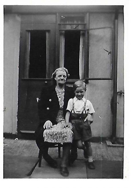 JOHN & GRANDMA FLORENCE BUGG OUTSIDE BACK DOOR OF 83b CARLETON RD 1952