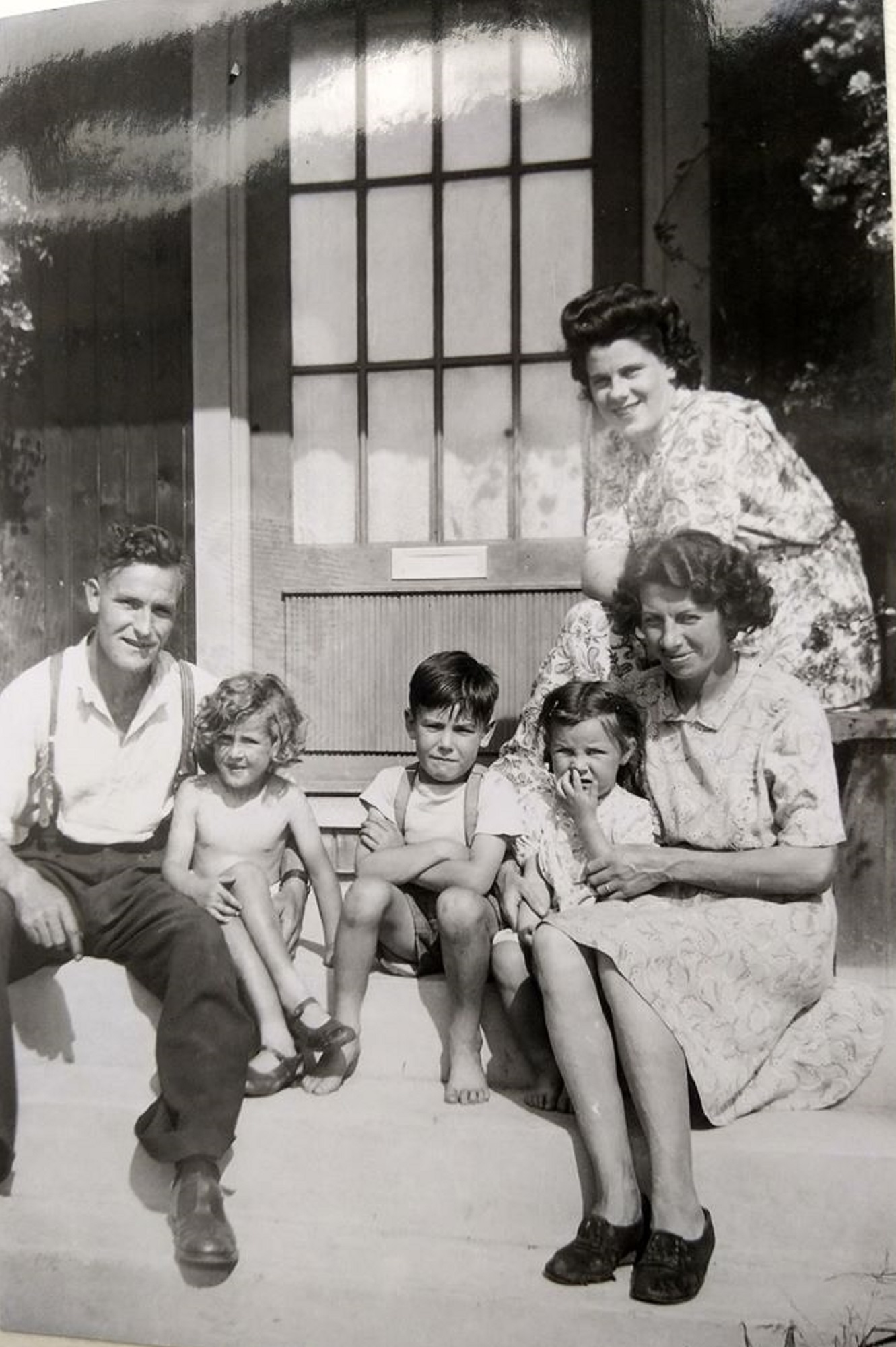 Three kids with Mum and Dad on the front porch. Swallow Street, Iver Heath, Buckinghamshire