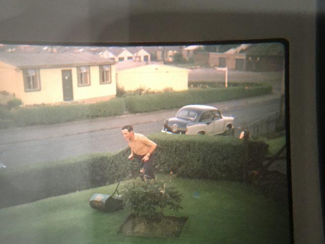 Dad mowing one of the front lawns