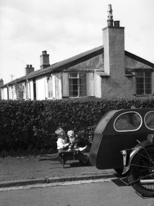 Child playing outside prefab in Dalmuir West, Clydebank