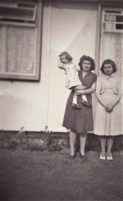 My aunt, cousin and mum outside my aunts prefab in Birchwood estate, Hatfield, Herts | John Hawthorne