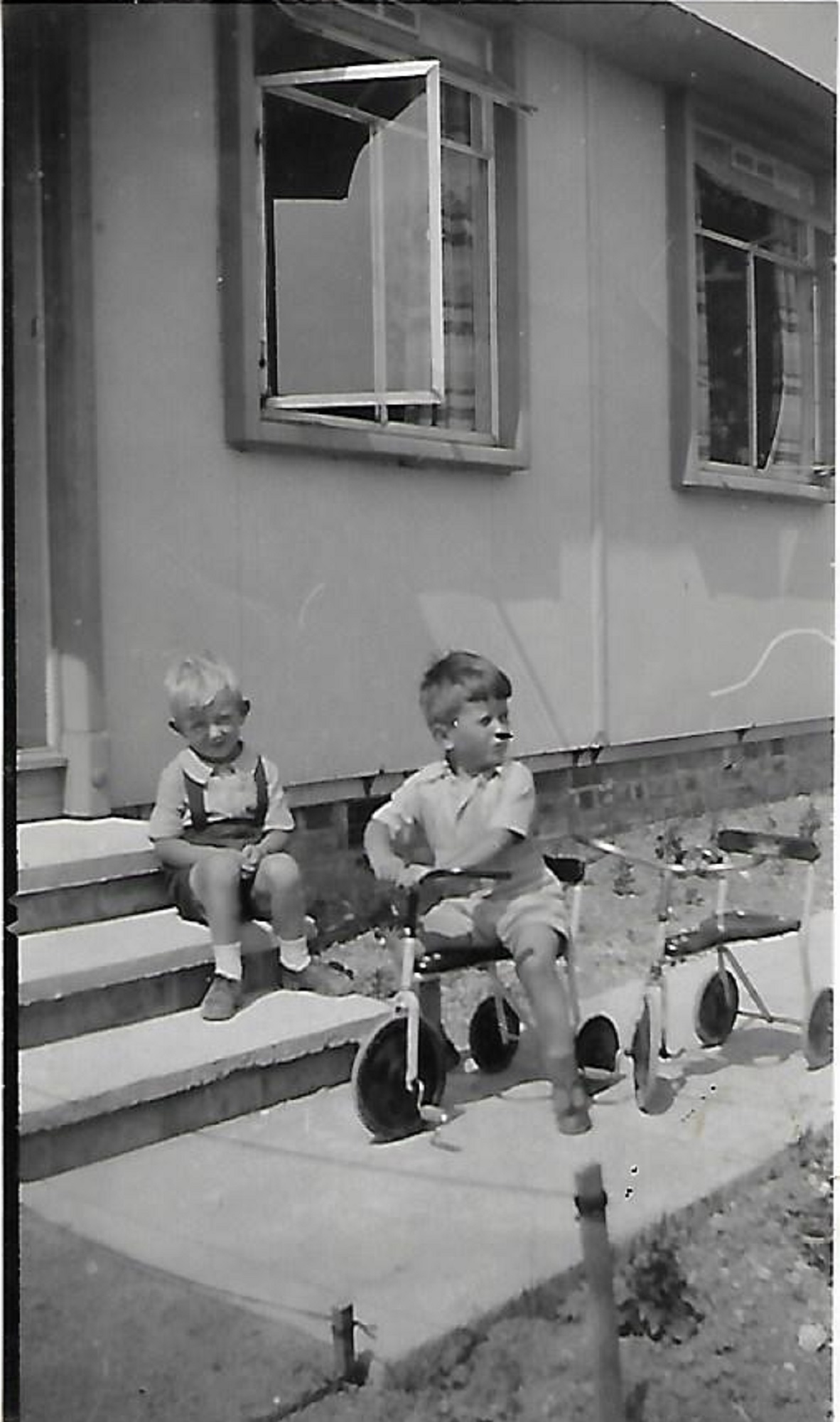 Pat on the tricycle and his friend John on the prefab step, Douglas Road, Lenham
