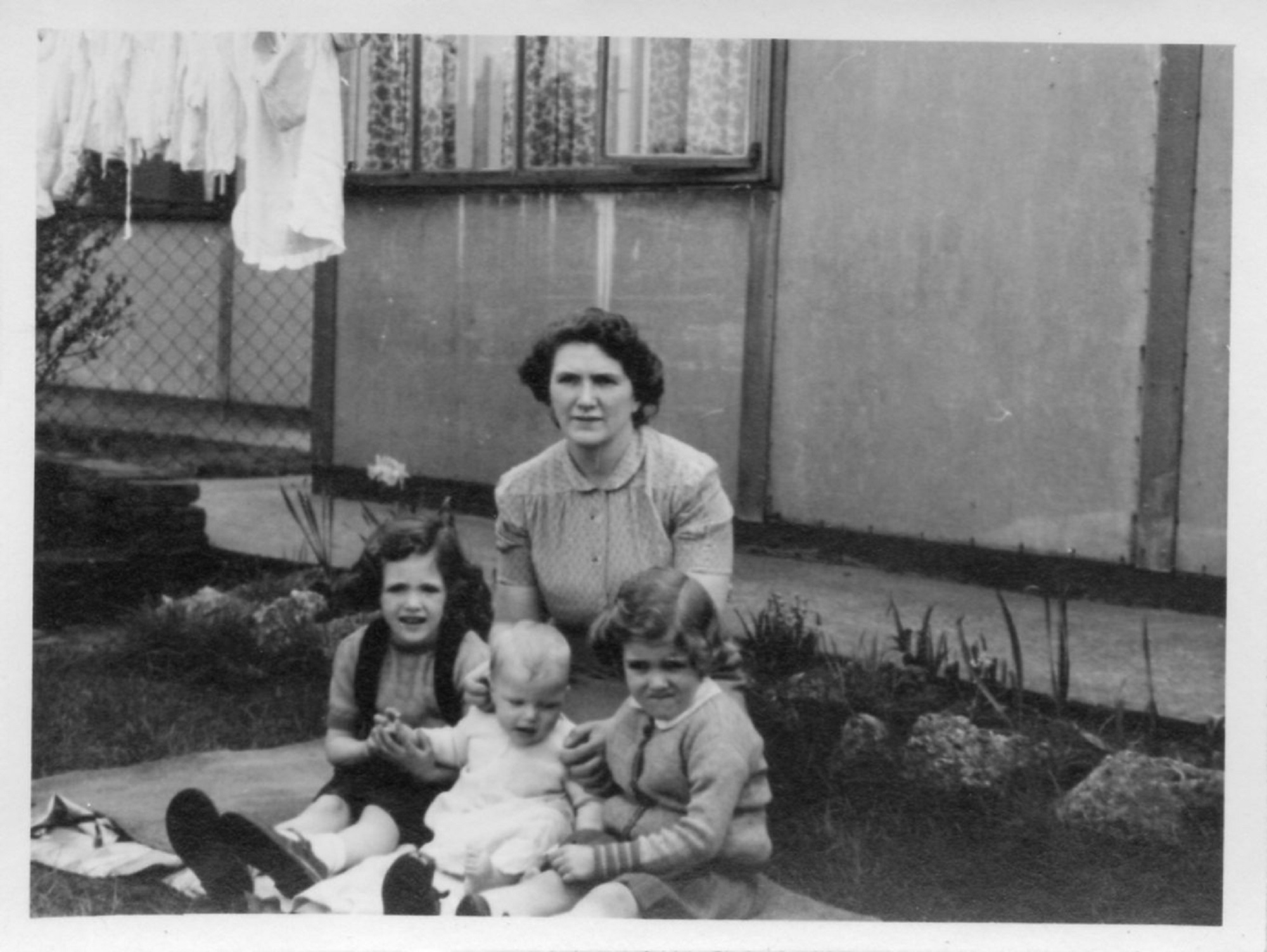 Christine, Robert and Pauline Flanders with their mum, Annie. 7 Hind Grove, Poplar, E.14. 1952