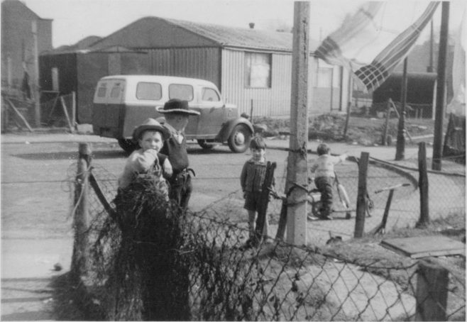 Nick Dowsett and Stephen Colwell playing cowboys in the banjo of Roding Avenue, Barking. No. 4 Roding Avenue is in the background | Nick Dowsett