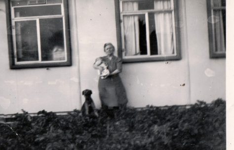 Winifred Arnold holding a baby (Roy Woollard) and a dog, plus dog sitting. 13 Mill Close, Ringmer