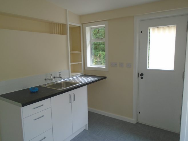 Kitchen showing plate rack and rebuilt cupboard, Wake Green Road prefab | Prefab Museum